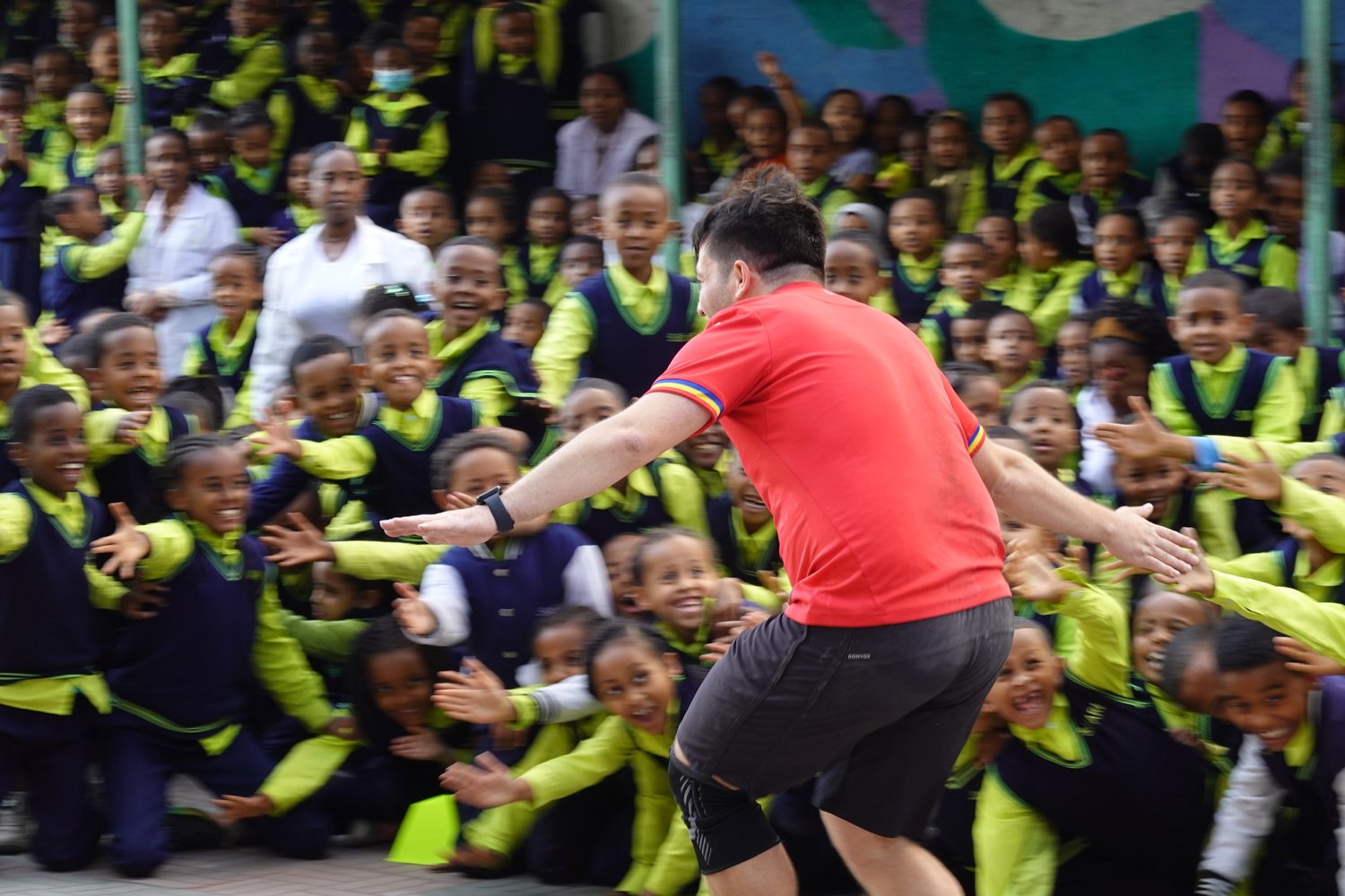 Playing with a crowd of school children